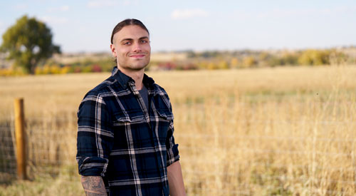 A Veteran standing in a field.