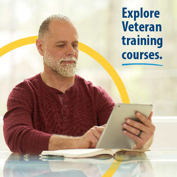 A Veteran sitting inside, using a tablet computer. Text on the image reads, “Explore Veteran training courses.” 