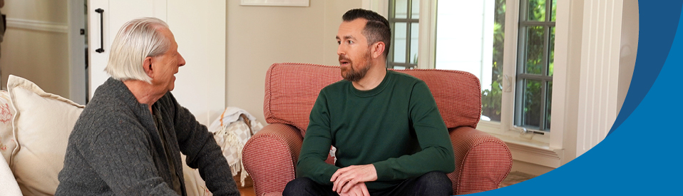 two veterans sitting in living room talking