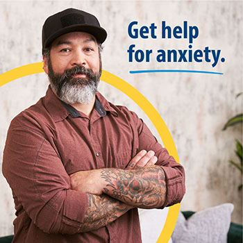A Veteran standing in a living room with text that says “Get help for anxiety.”